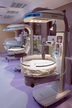 an empty hospital room with medical equipment on the floor and in the background, lights are turned on