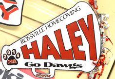 a sign that says haley on it with red and white streamers around it