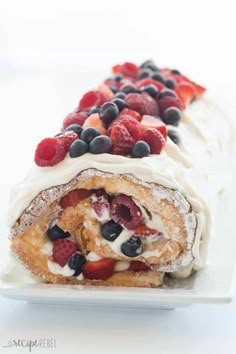 a pastry filled with berries and cream on top of a white plate