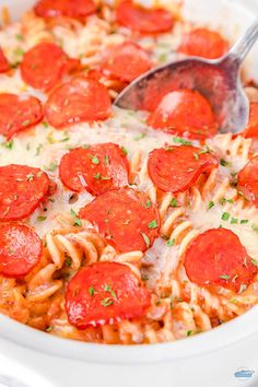 a close up of a plate of pasta with pepperoni