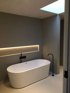 a large white bath tub sitting in a bathroom