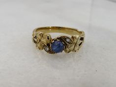 BEAUTIFUL ESTATE 14K YELLOW GOLD SAPPHIRE AND DIAMOND BAND RING. SIZE 6.5. GREAT SHAPE. 3.3 GRAMS. 6.6MM WIDE. UNMARKED ACID TESTS FOR 14K. 4.3MM CAB SAPPHIRE TWO SMALL DIAMONDS. WILL COME IN NICE RING BOX.PLEASE BE ADVISED SOME PHOTOS ARE CLOSEUPS TO SHOW DETAIL, PLEASE READ FULL DESCRIPTION FOR BETTER UNDERSTANDING OF SIZE.  This item is preloved and Antique/Vintage. This means it may have signs of wear and use and is offered as is.  You will receive the exact item shown in the photos. There m Gold Multi-stone Sapphire Ring For Anniversary, Antique Sapphire Ring, Vintage Rings Antiques, Antique Sapphire Engagement Rings, Daisy Engagement Ring, Quirky Ring, Stone Ring Design, Sapphire And Diamond Band, Vintage Sapphire Ring