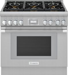 a stainless steel oven with four burners