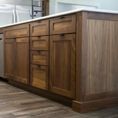 a kitchen with wooden cabinets and stainless steel dishwasher