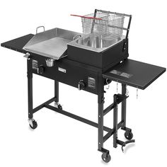 an outdoor grill on wheels with a basket over the burner for cooking and serving