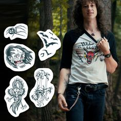 a man with long hair and tattoos standing in the woods