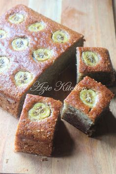 sliced banana cake on a wooden table with slices cut out and ready to be eaten