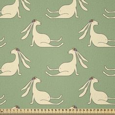 a green background with white rabbits on it