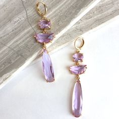 Long, Light Purple Amethyst Glass Prong Set Stone, Gold Earrings Three Faceted, Light Purple Amethyst Glass Stones Are Prong Set And Suspended From Easy And Secure Lever Back Ear Hooks. Excellent Quality Gold Plated Settings And Lever Back Ear Wires, Glass Stones. Approx. Size: 2-1/2"L, 5/8"W *Available In Other Colors *See My Other Listings & Last Photos New, Handmade: Jpeace Designs Purple Amethyst Gemstone, Alexandrite, Vintage, Wedding Jewelry, Movie Star Red Carpet, Statement Jewelry Lavender Amethyst Earrings For Party, Lavender Jewelry, Lavender Jewellery, Lavender Earrings, Long Gold Earrings, Gold Jewelry Sets, Prom Jewelry, Purple Jewelry, Purple Earrings