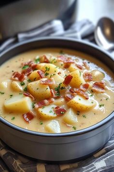 a bowl filled with potatoes and bacon on top of a table