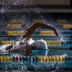 a man swimming in the water with his arm extended