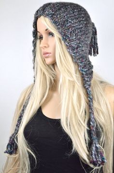 a woman with long blonde hair wearing a knitted hat