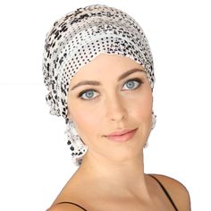 Original Chemo Beanies® created by survivors for survivors as a simple solution to the added burden women face during a serious health crisis. White with Black Floral Ruffle Signature slip-on beanie adds feminine volume, producing the subtle look and feel of having hair. The unique elastic design stretches for a comfortable and easy fit. Slips on and off with ease; No tying necessary. Our patented design features a fluent fabric flap for a polished look that provides full coverage around the nap Chemo Beanies, Chemo Hats, Chemo Headwear, Pretty Scarves, Bald Women, Women Face, Chemo Hat, Floral Ruffle, Head Covering