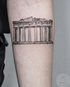 a black and white photo of an arm with a tattoo on it that has a drawing of the parthenion