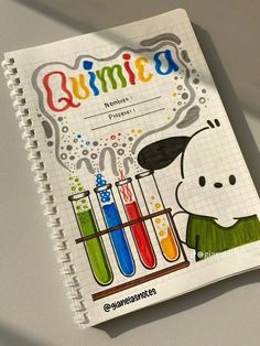 a spiral notebook with an image of a dog holding test tubes filled with colored liquid