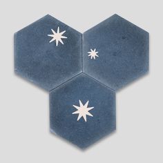 three hexagonal tiles with white stars on them