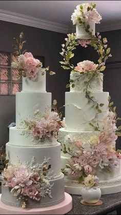 three tiered wedding cakes with flowers on them