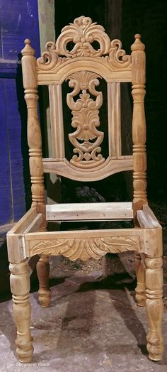 a wooden chair sitting on top of a cement floor