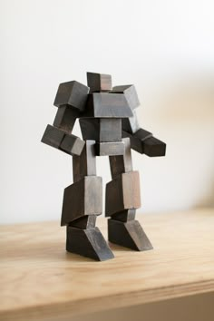 a wooden sculpture on top of a wooden table