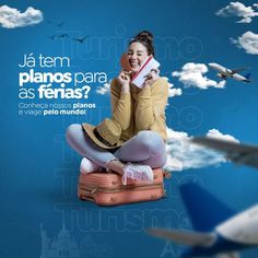 a woman sitting on top of a suitcase in front of an airplane flying above her