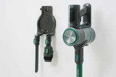 there are two different types of tools hanging on the wall, one is green and the other is black