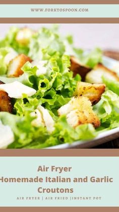 a close up of a plate of food with lettuce and croutons