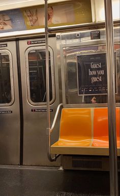 an empty subway car with orange seats and a sign on the door that says go get how you guest