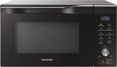 a black samsung microwave oven with the door open and timer on it's side