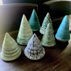 several small glass trees sitting on top of a wooden table