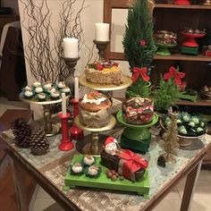 a table topped with lots of different types of cakes