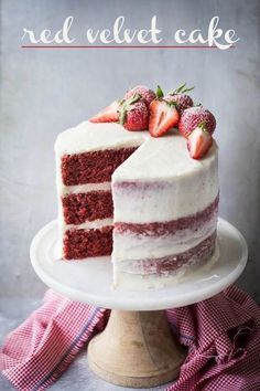 a red velvet cake with white frosting and strawberries on top