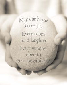 someone holding a ball in their hands that says, may your home know joy every room hold laughter every window open to great possibilities