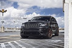 a black jeep parked in an empty parking lot