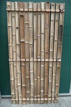 a large bamboo fence made out of wooden planks on the side of a building