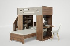 a bunk bed with built in desk and bookcases on the bottom level, next to a white chair