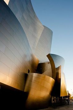 the exterior of walt concert hall in los angeles, california with people walking by it