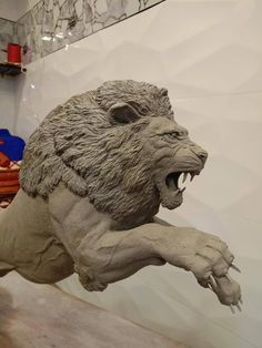 a statue of a lion with its mouth open