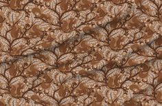 an image of a brown and white fabric with leaves on the side, in front of a ruler