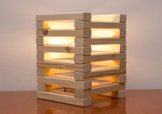 a light made out of wooden blocks sitting on top of a table