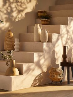 vases are sitting on the steps in an outdoor setting