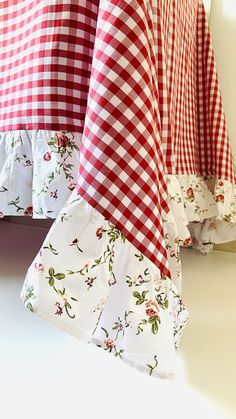 red and white checkered bedspreads with ruffles on them are displayed