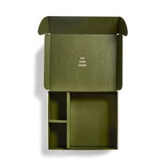 an open green box with two compartments on the inside and one section opened to show it's contents