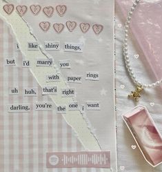 a piece of paper with words on it next to a bead necklace and other items