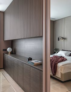 a bed sitting next to a wooden wall in a bedroom