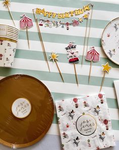 a table topped with paper plates and cupcakes