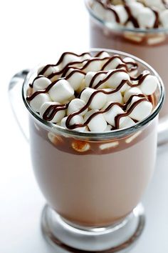 two glasses filled with hot chocolate and marshmallows