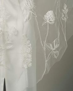 white sheer fabric with flowers and leaves on it