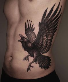 a man's stomach with an eagle tattoo on his chest and the lower half of his body