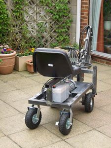 a small cart with a gas can on it's back wheels sitting in front of a house