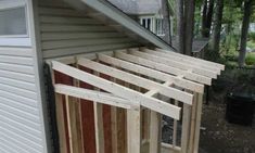 the side of a house that is being built with wood planks and siding on it